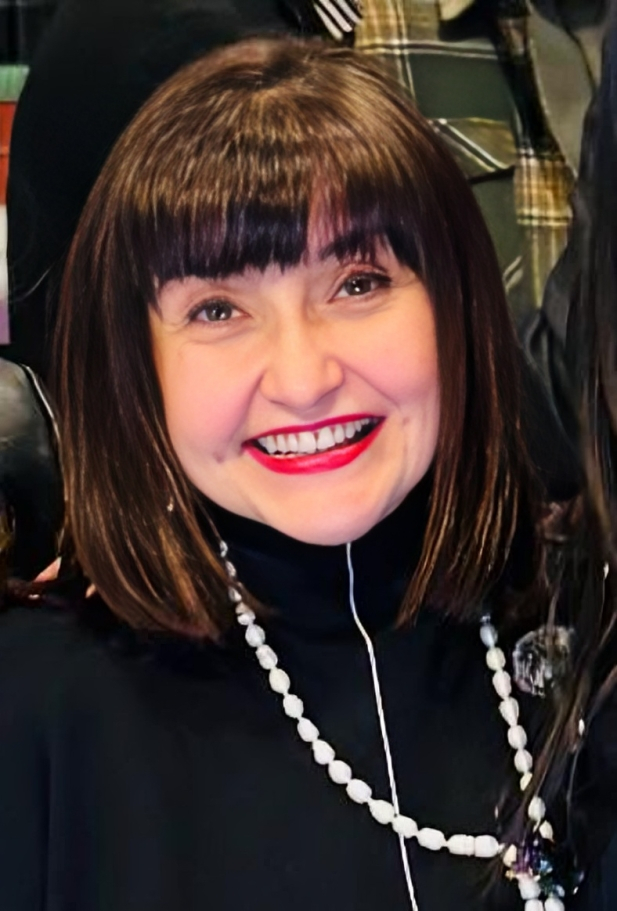 a tree with red flowers and green leaves
