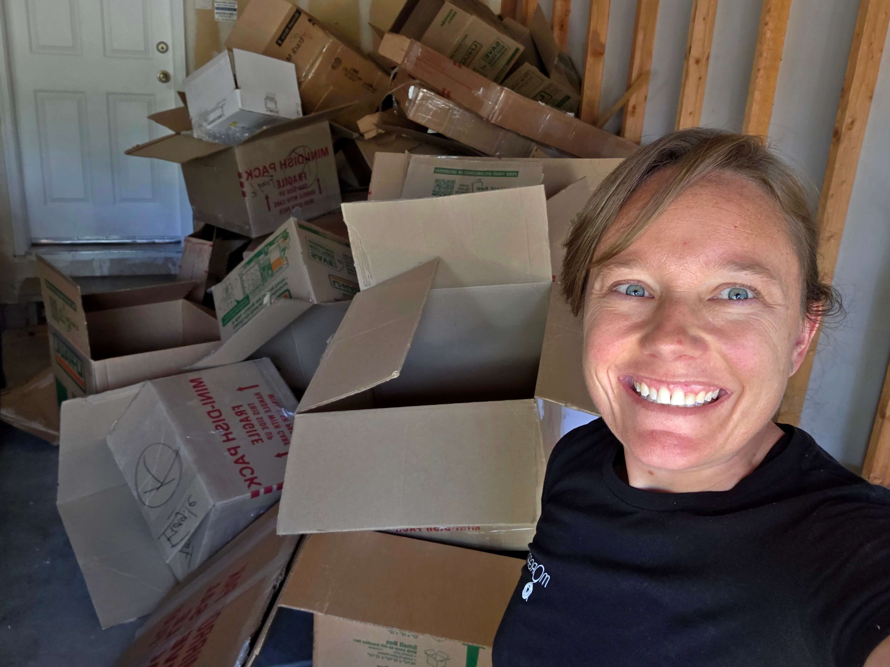 Picture of owner packing boxes for a moving client