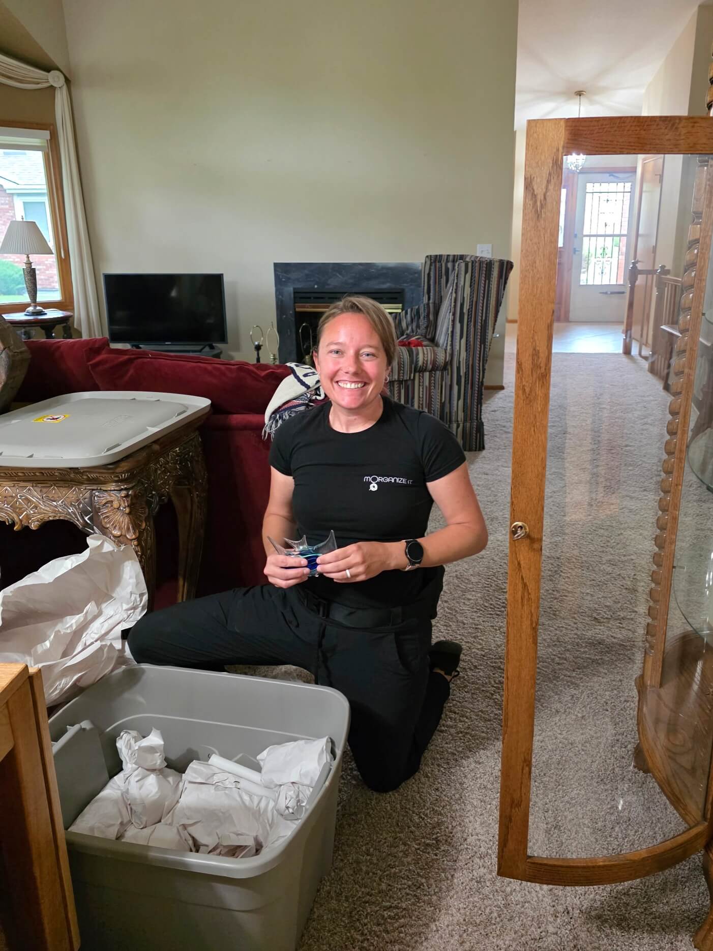 Photo of owner packing fragile items for a moving client