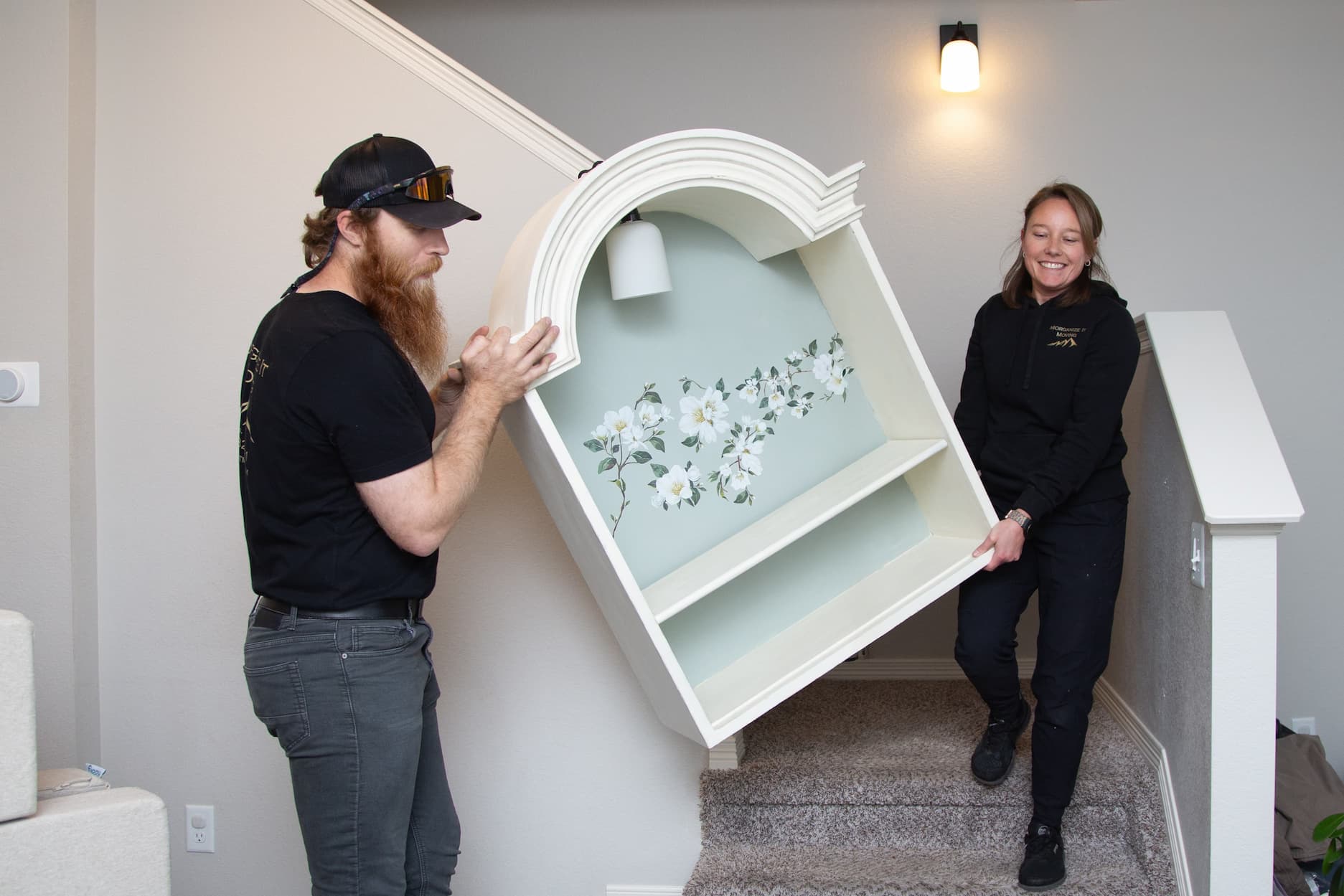 Picture of moving employees moving a delicate piece of furniture