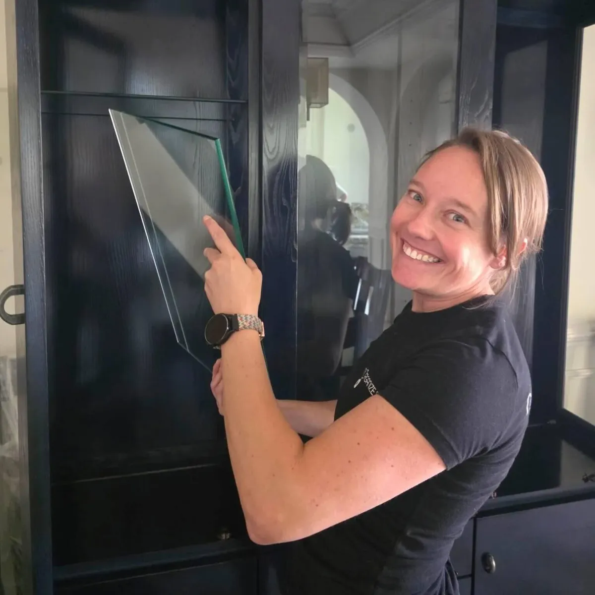 Picture of owner unpacking and placing glass shelf in china cabinet