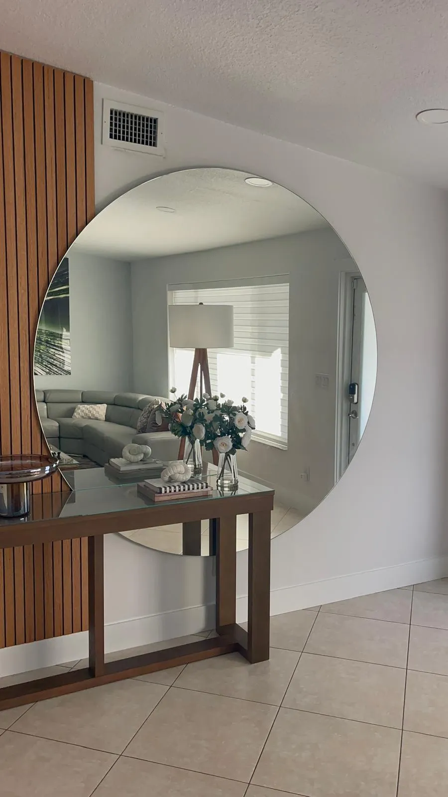 Bedroom with bed, television, and open doorway to bathroom.