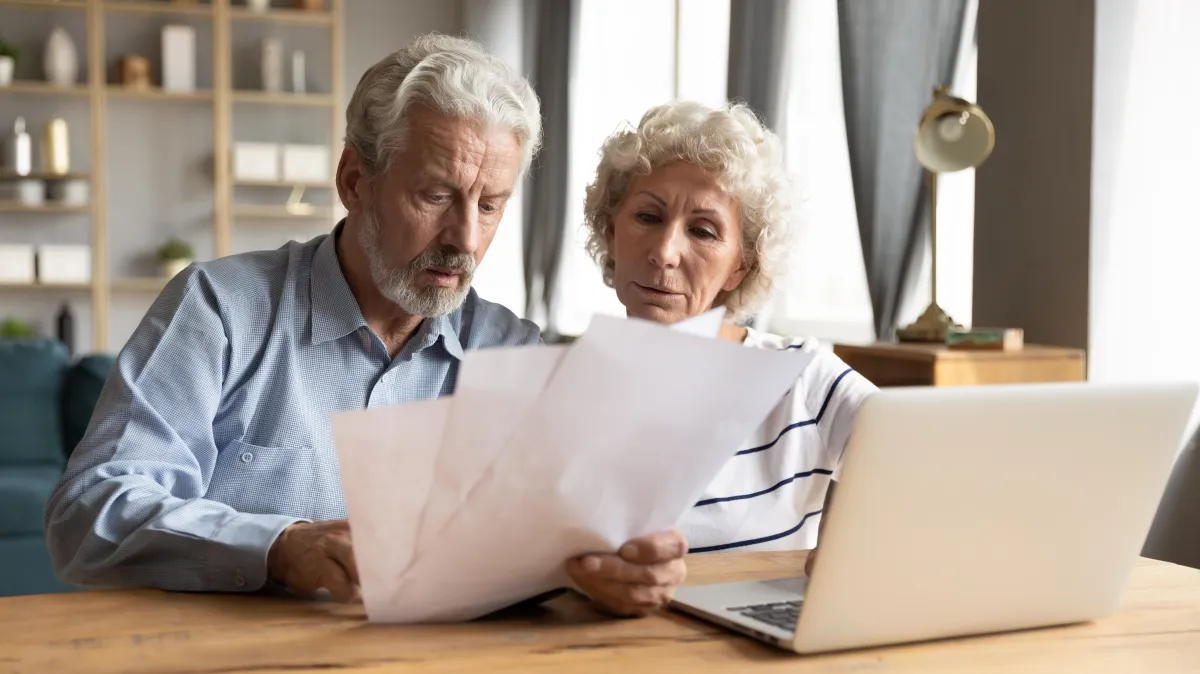 person at computer looking to invest into property 
