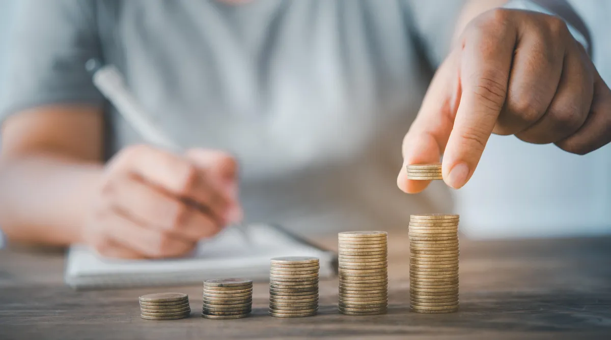 man stacking coins