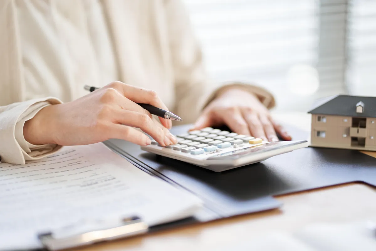 woman typing on calculator 