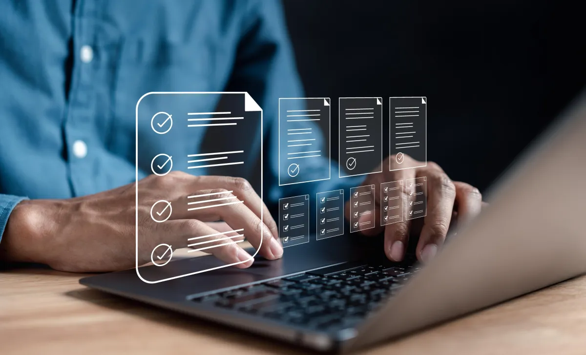 man at computer looking at different documents