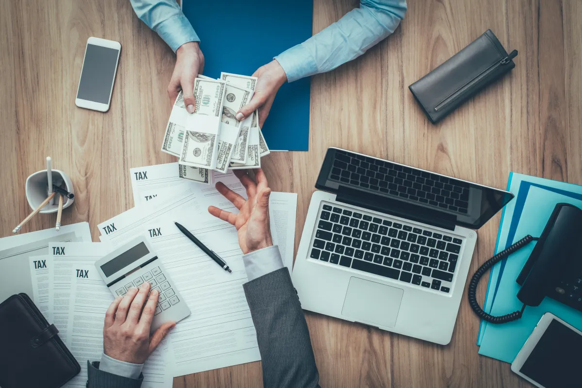 person handing money over for taxes