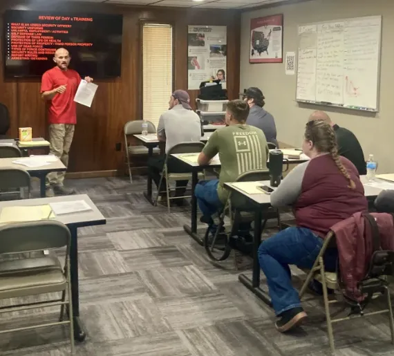 Security instructor leading a licensed guard training class at Absolute Protection Academy in Nashville, Tennessee.