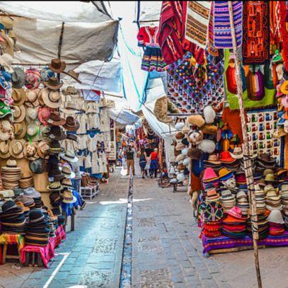man standing on rock formation under cloudy sky during daytime