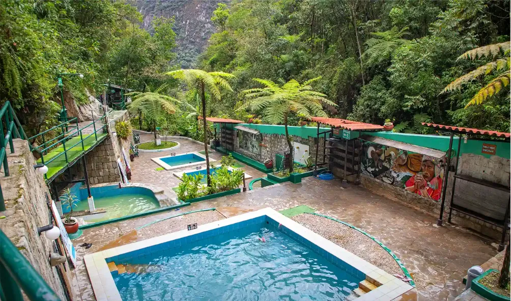 man standing on rock formation under cloudy sky during daytime
