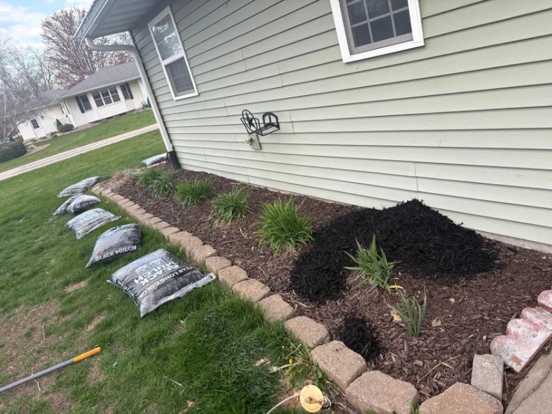 Mulch installation in Iowa City Iowa enhancing landscape beds and improving overall appearance
