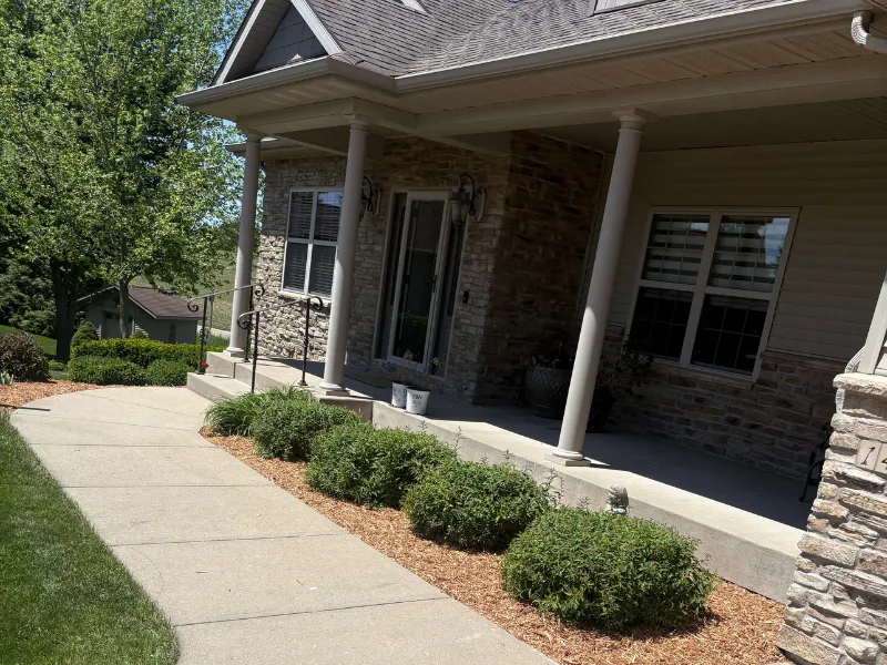 Hedge and shrub trimming in Kalona Iowa maintaining clean and well shaped landscaping