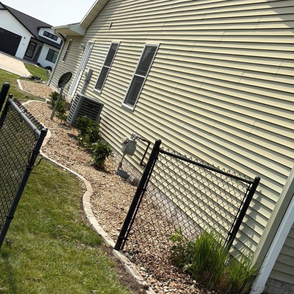 Rock landscaping in Mt Pleasant Iowa improving side yard drainage and appearance