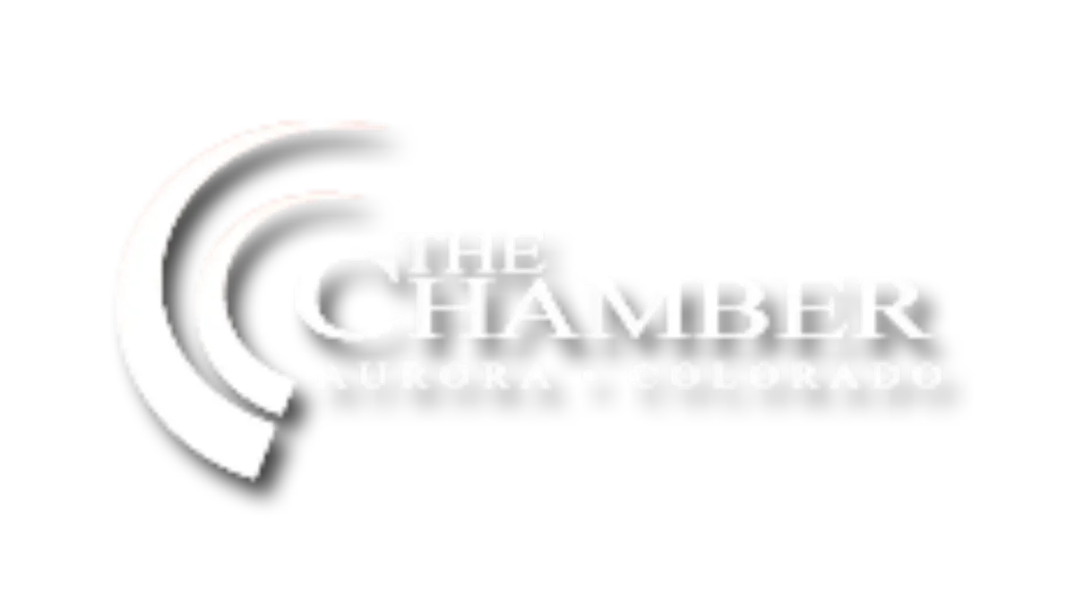 Aurora Chamber of Commerce logo - White text on a black background, featuring 'The Chamber' in bold serif font with 'Aurora - Colorado' below it, accompanied by three stylized curved lines to the left of the text.