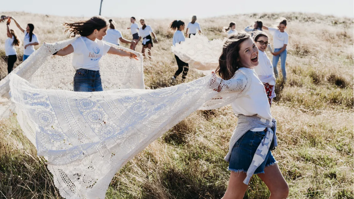 group of young girls dancing in field