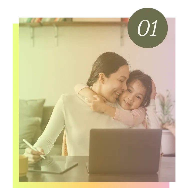 Child hugging mum while she uses a laptop, symbolising parents joining the Grate Adventures online feeding therapy community.