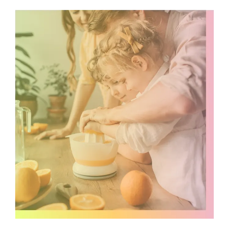 Family sueezing oranges together, reflecting Kristy Jordan's early work helping children explore food in everyday moments.