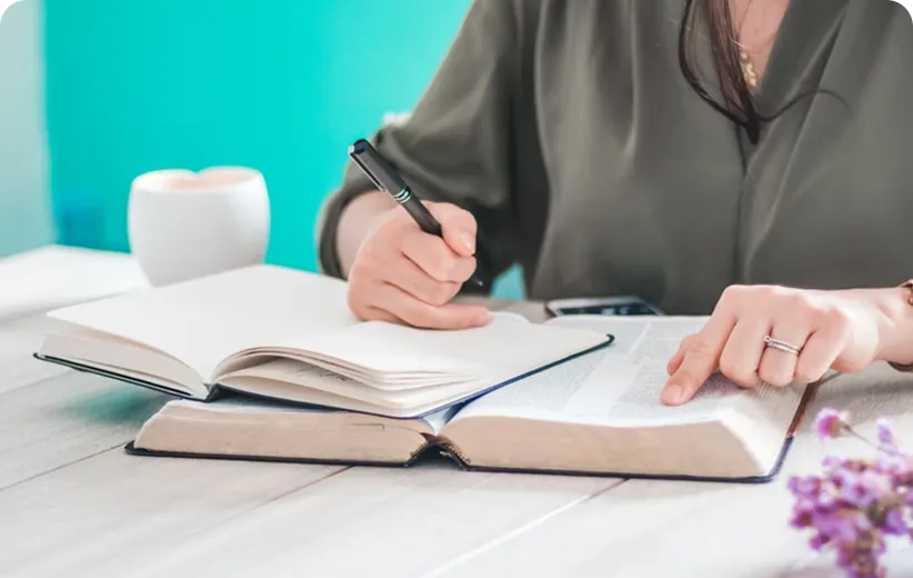 young child writing on a notebook