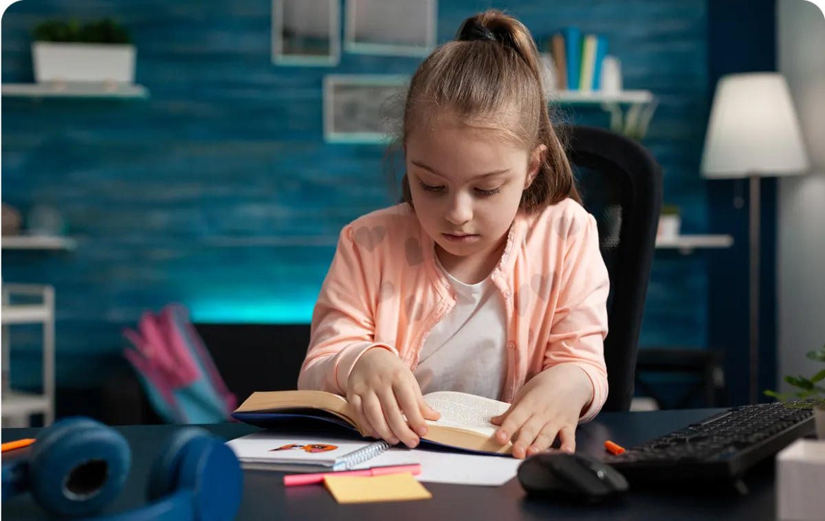 young child writing on a notebook