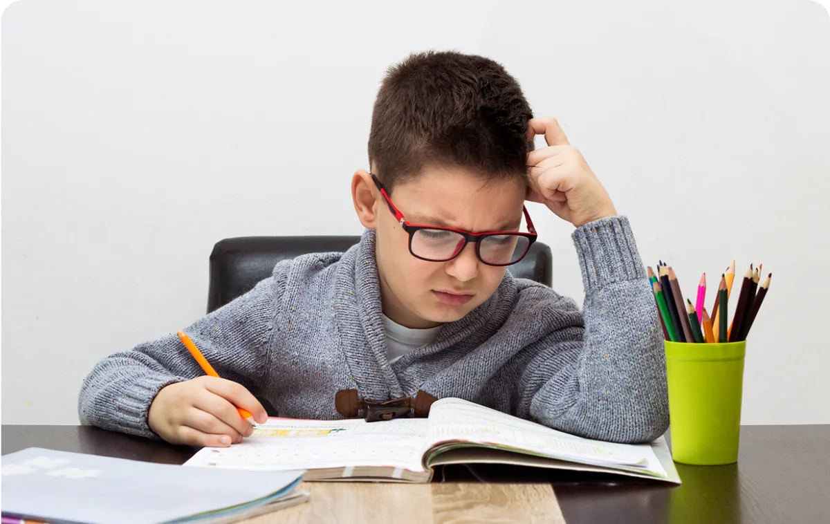 young child writing on a notebook