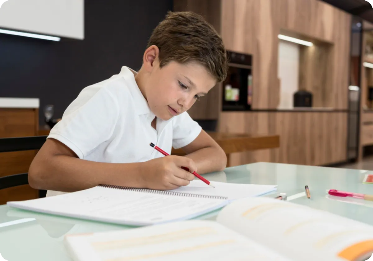 young child writing on a notebook