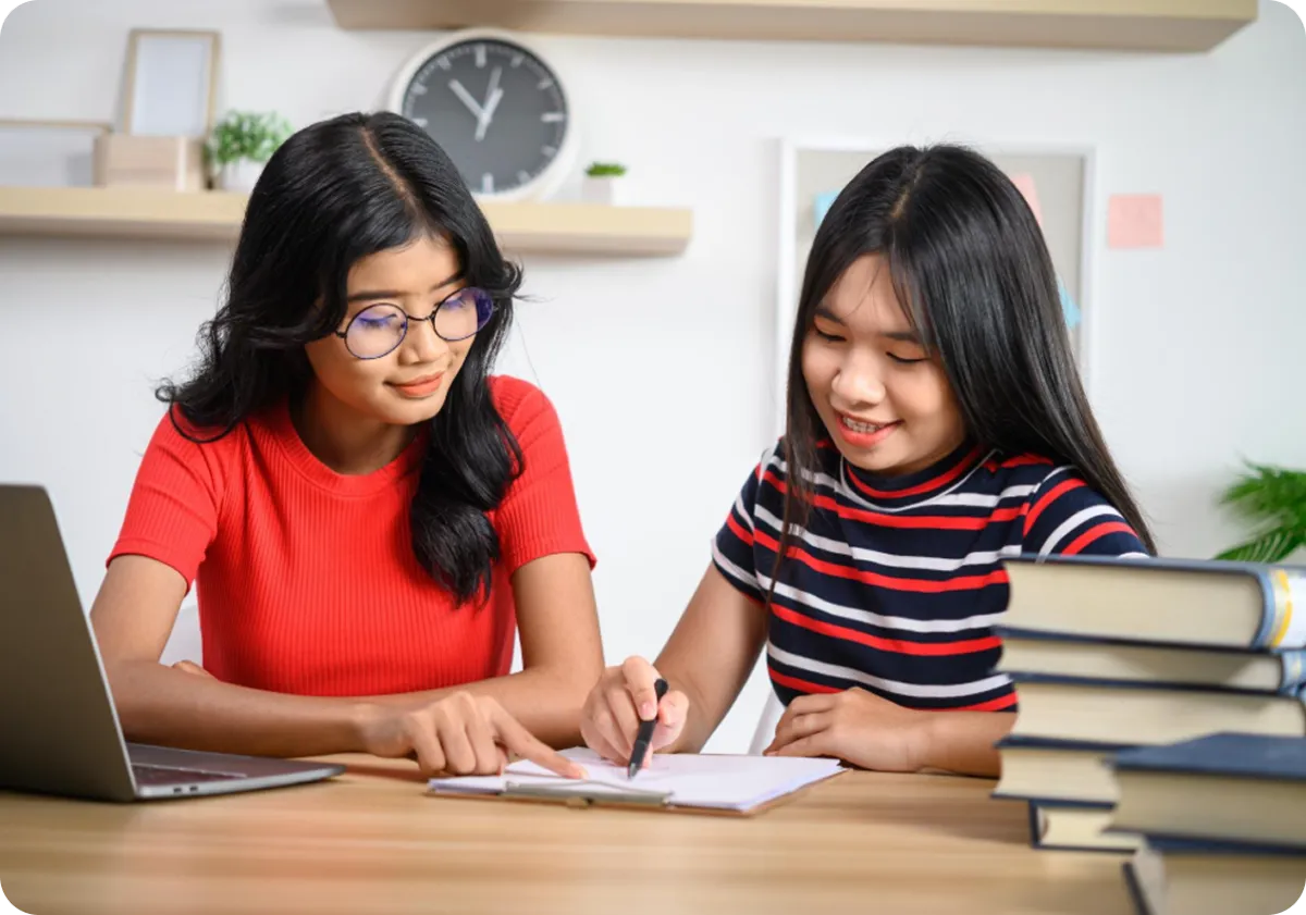 young child writing on a notebook