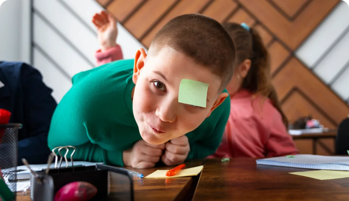 young child writing on a notebook