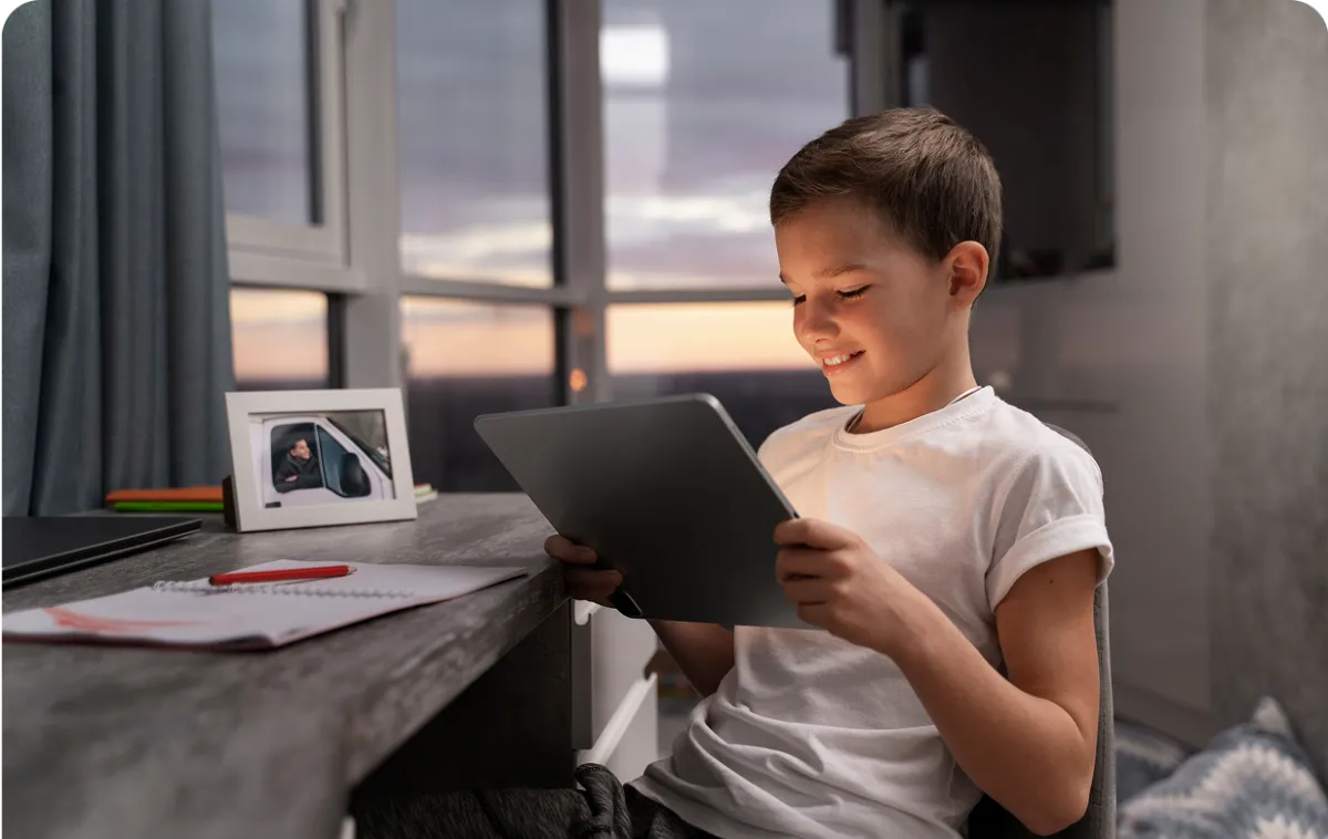 young child writing on a notebook