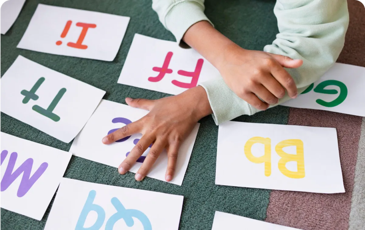 young child writing on a notebook