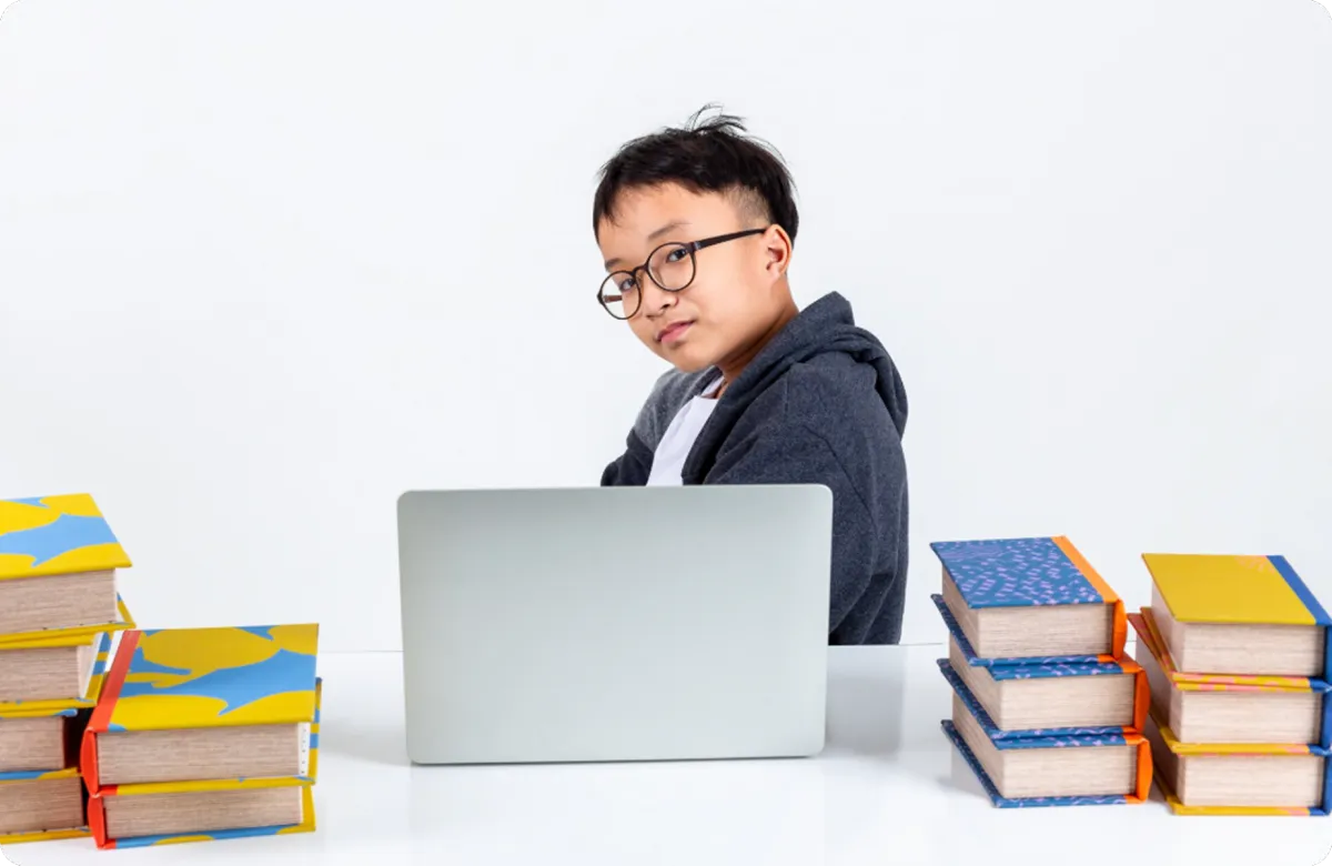 young child writing on a notebook