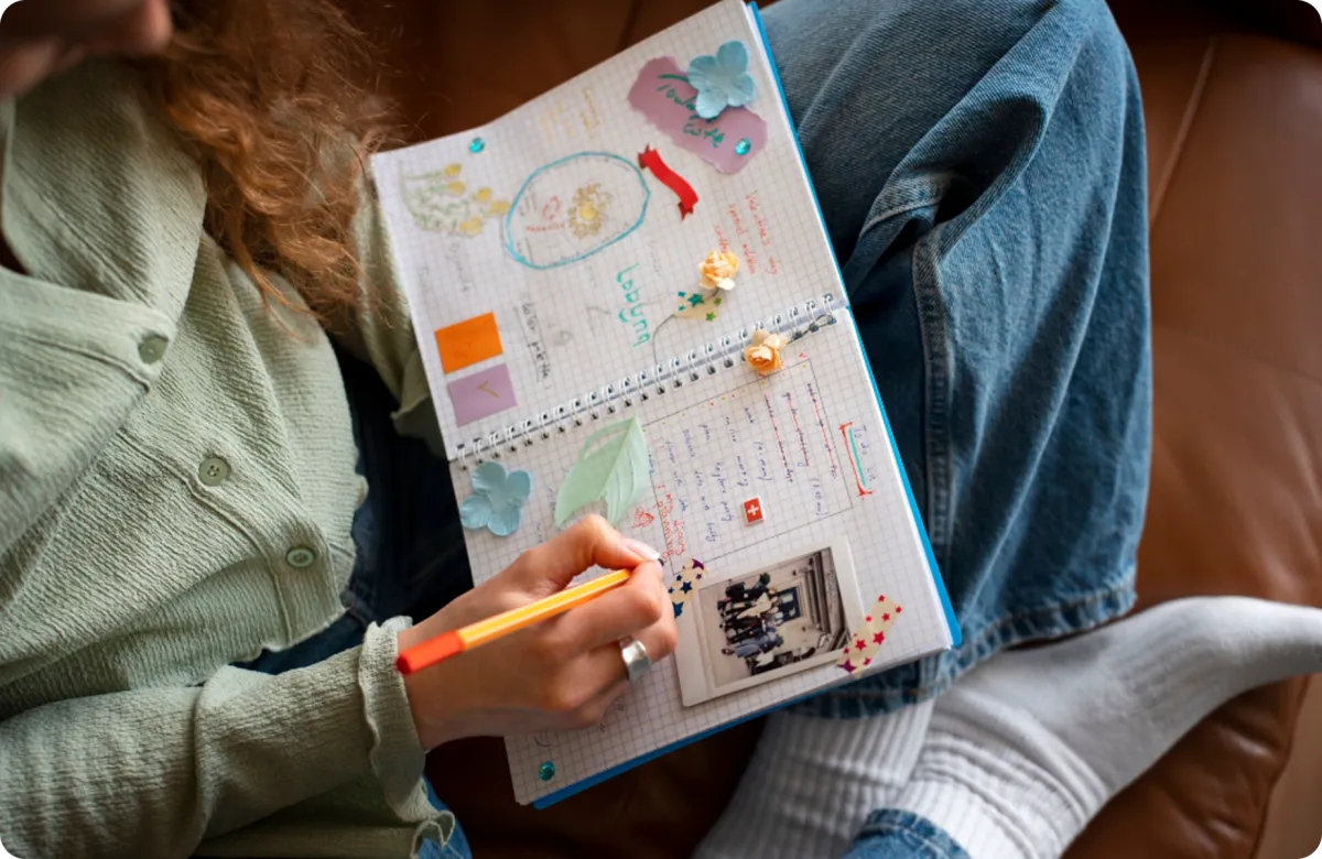 young child writing on a notebook
