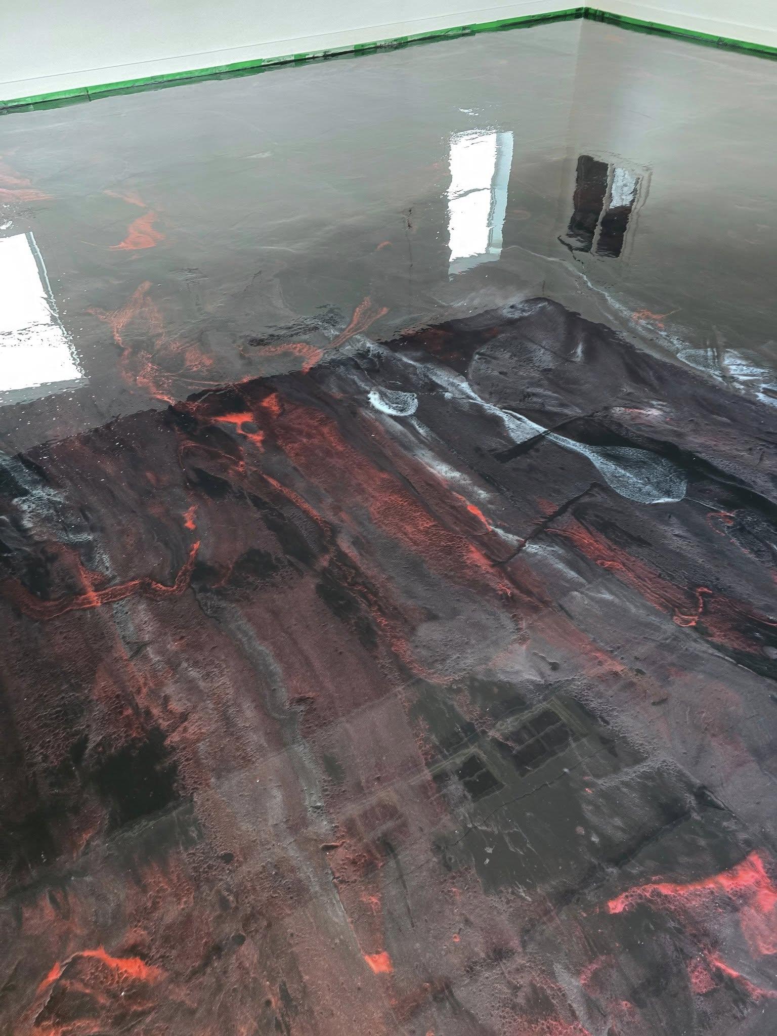 Epoxy garage floor, clean glossy decorative flake finish, neutral lighting, full-floor view