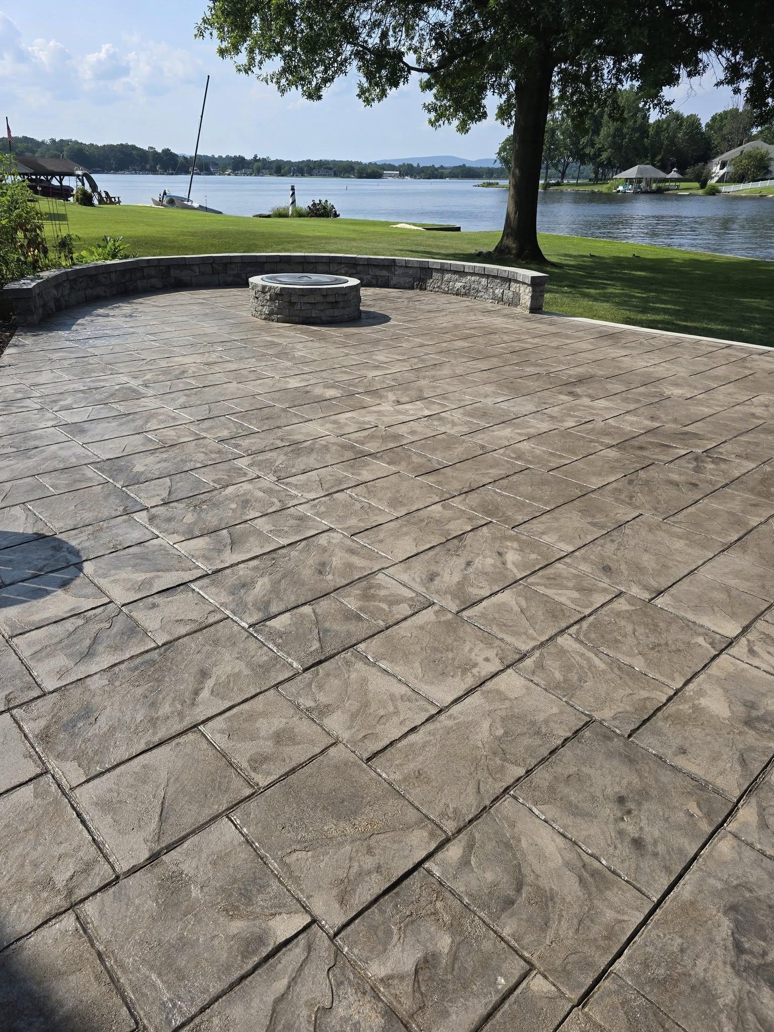 Technician applying concrete sealer to a slab (roller or spray)