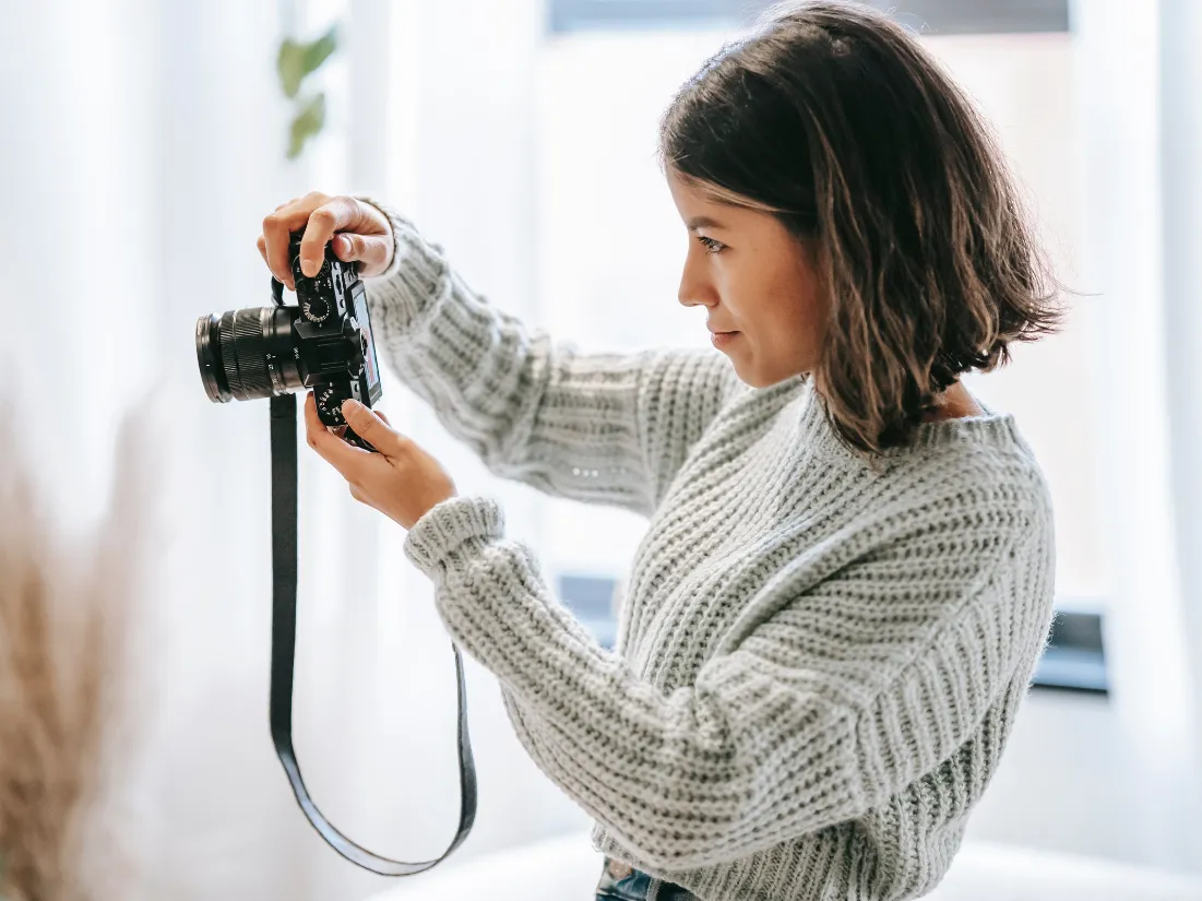 Woman photographing a home for sale