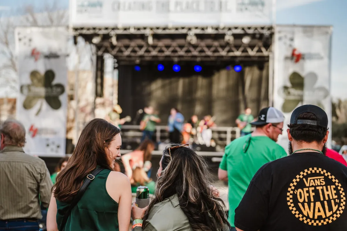 Evening crowd under string lights in downtown Wichita Falls during the festival.