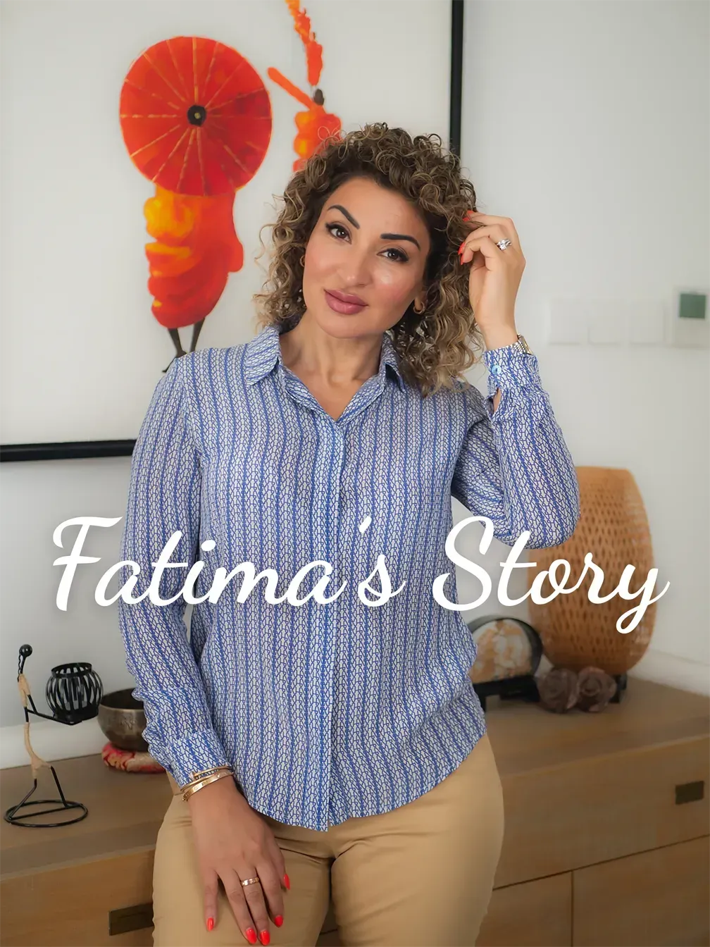 Portrait of Fatima standing in a blue patterned shirt, smiling warmly at the camera.