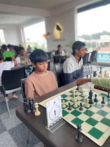 Students at CHESS KLUB with Trophies on a Stage
