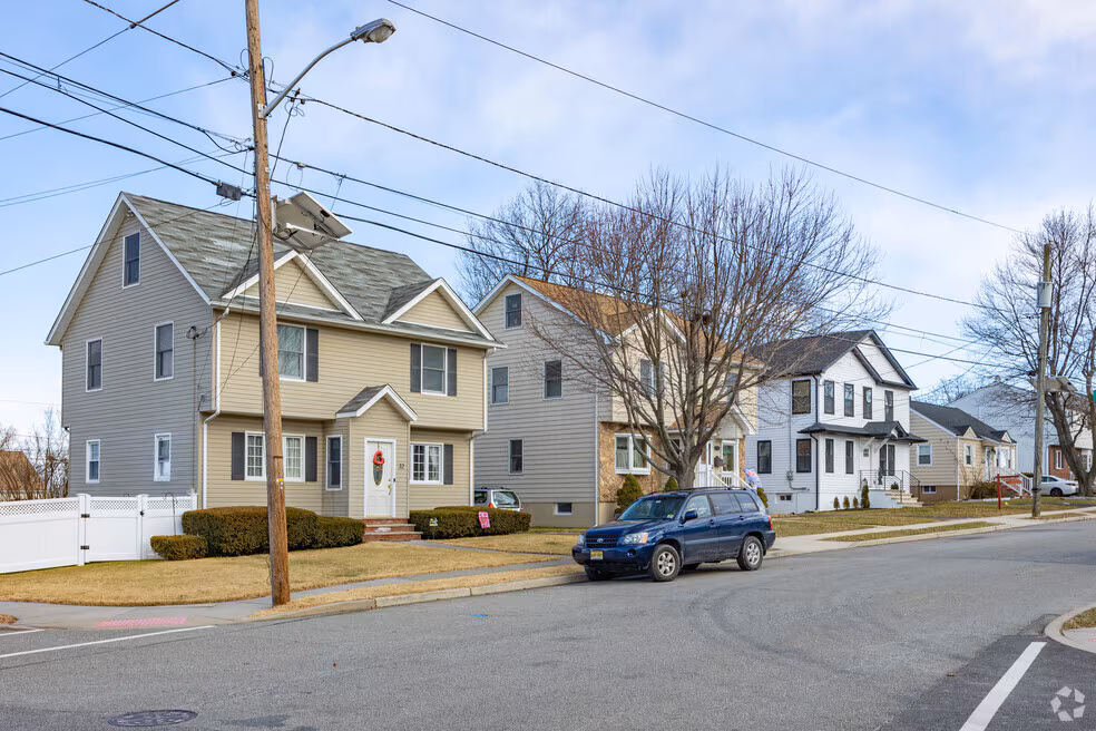 covered deck with cedar pergola next to traditional home in Albion Clifton NJ