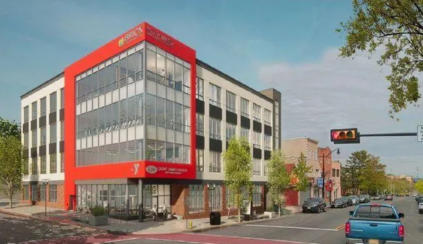 backyard deck with pergola and stairs behind two-story home in South Ward Newark NJ