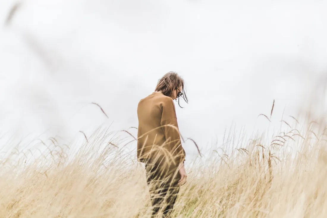 Person pausing to take a mindful breath amid a busy, worry-filled day