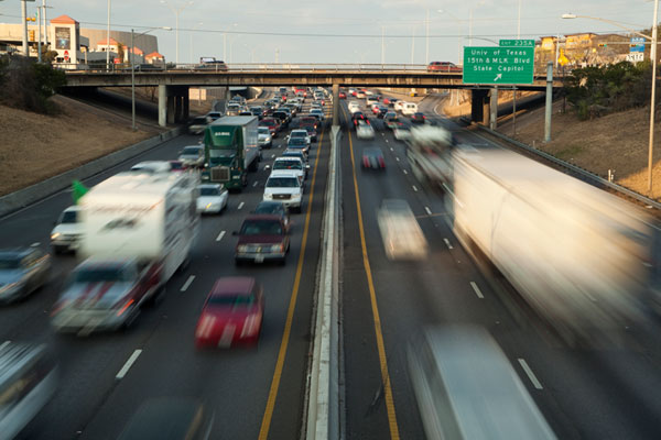 Congested lanes of highway traffic, seen from above as one interconnected flow