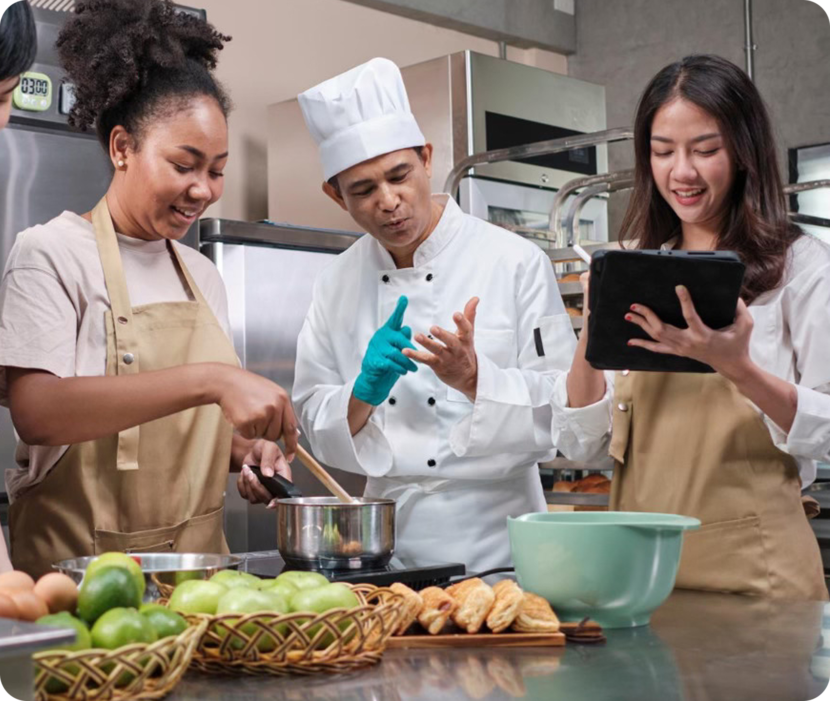 A line cook learning on a tablet at a prep station, representing fast, accessible learning.