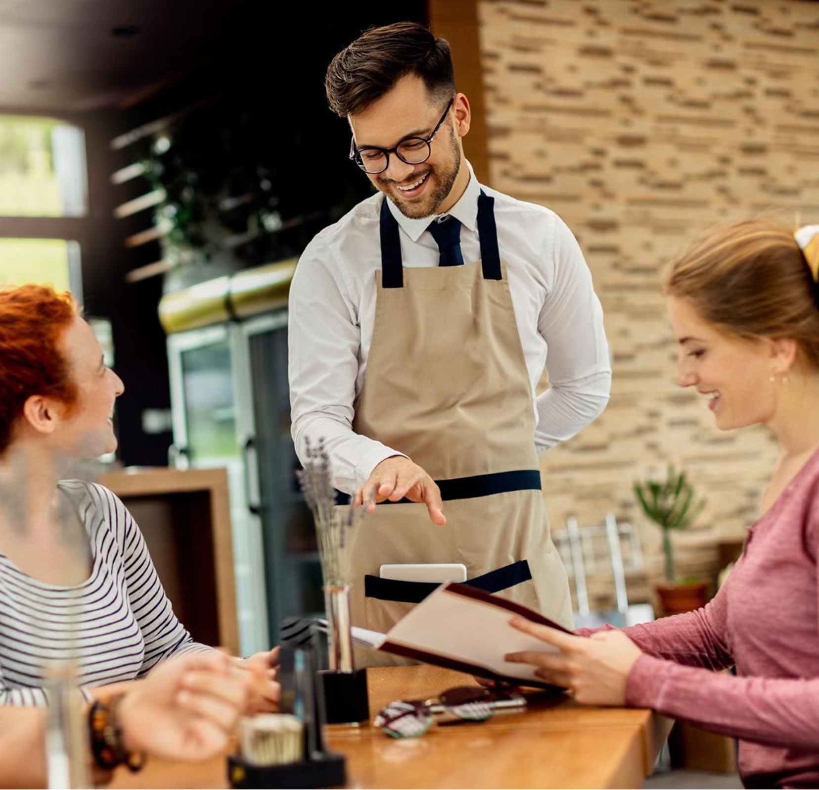 A line cook learning on a tablet at a prep station, representing fast, accessible learning.