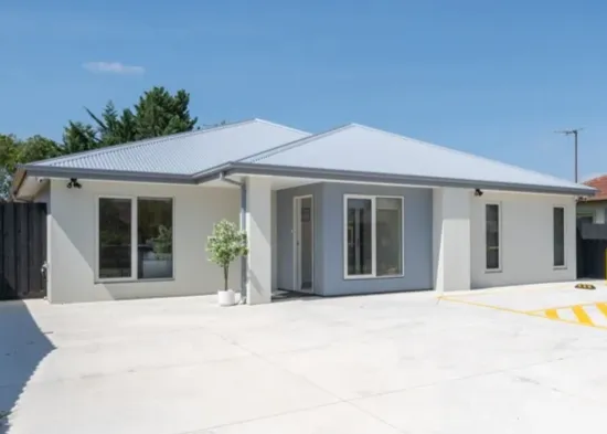 a woman sitting on a couch talking to another woman