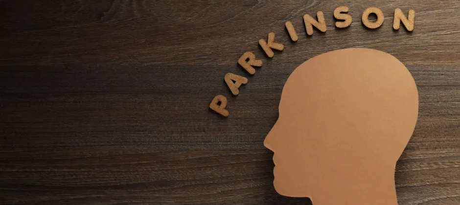 wooden background with head silhouette and "Parkinson" above it