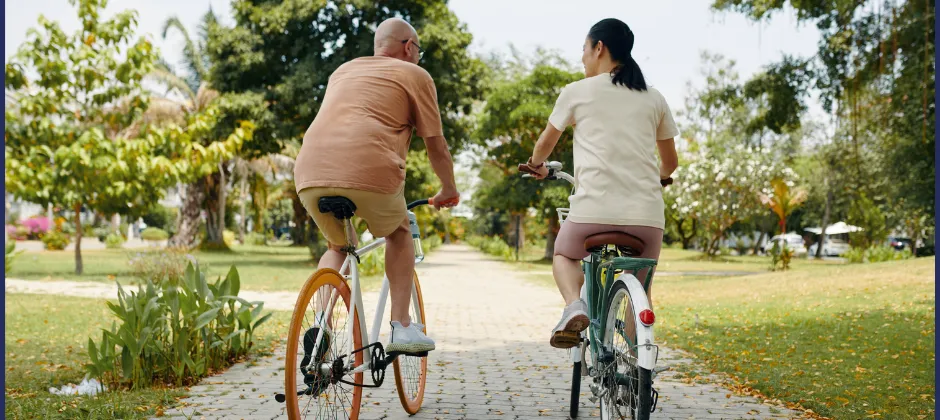 two people riding bikes outside