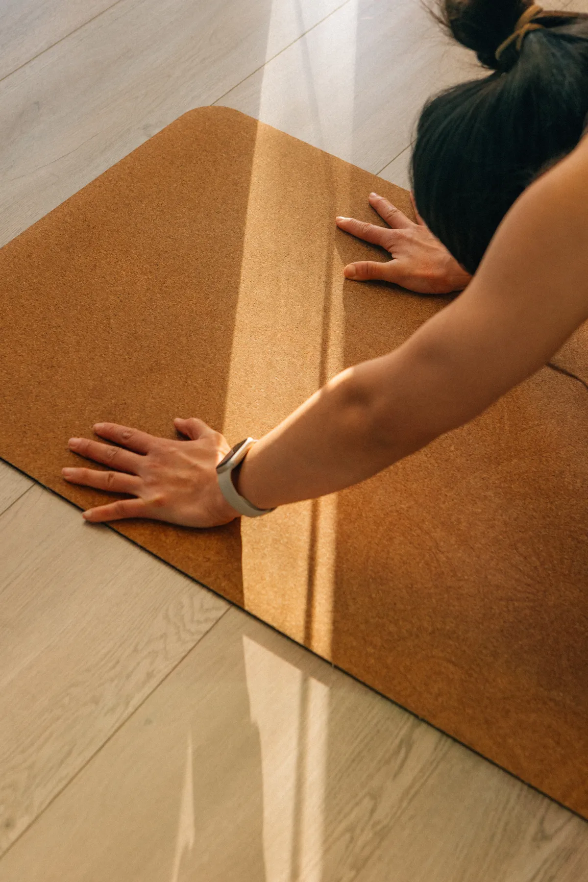 Square macro photo of hand resting on textured stone floor during silent pause