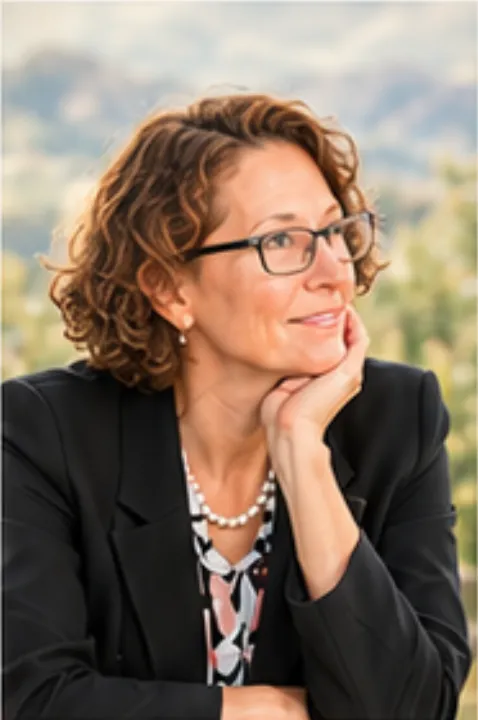 Portrait of Dr. Caroline Triebold, a woman with glasses looking off to the side.