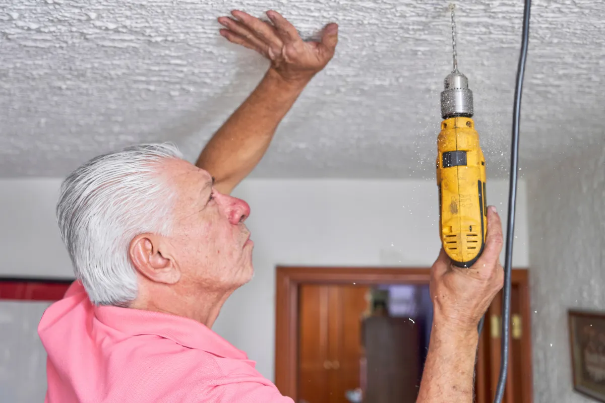 Senior homeowner reviewing home maintenance needs before applying for a reverse mortgage.
