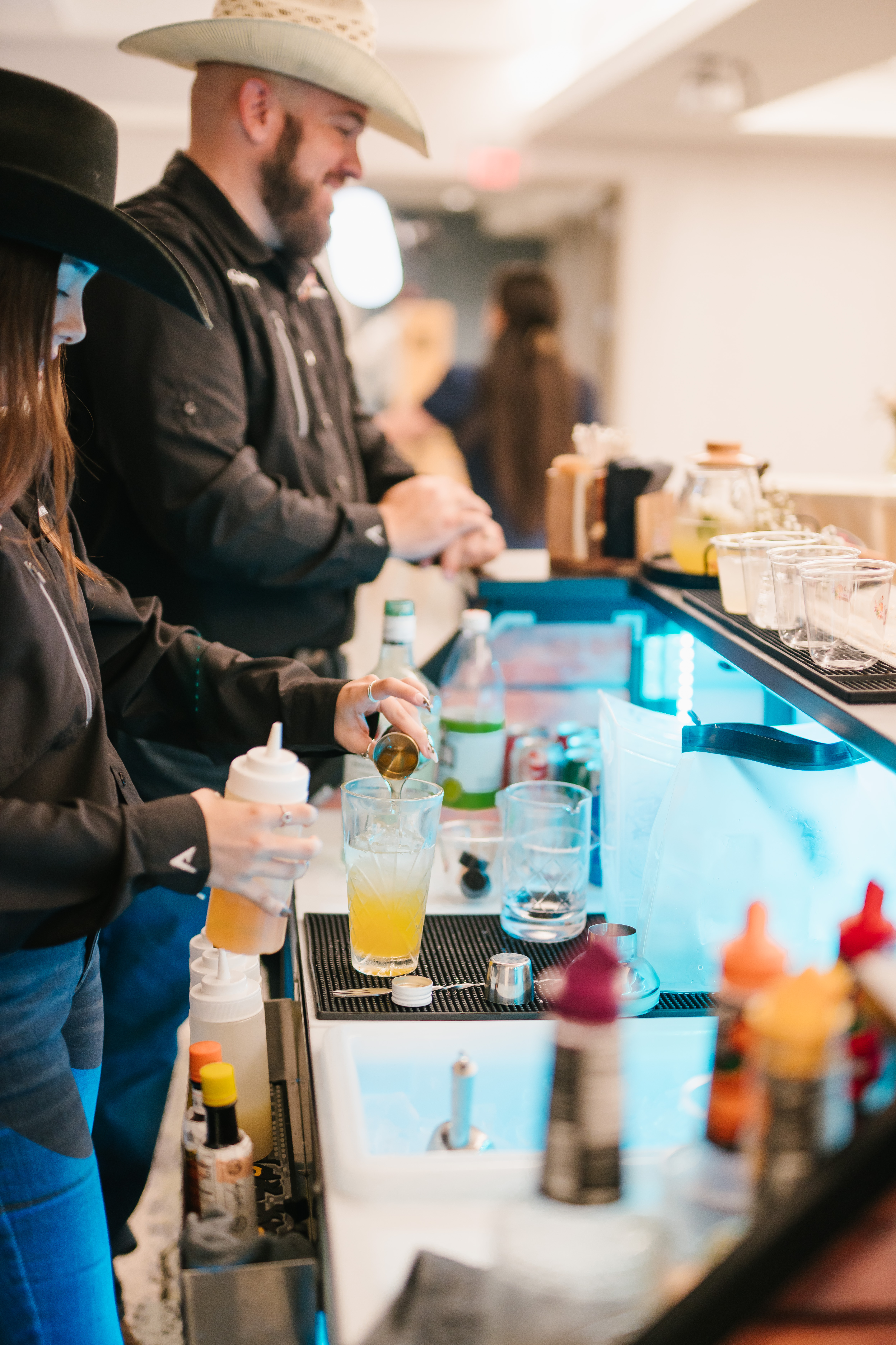 Mobile bartending service in San Antonio preparing custom cocktails at a wedding and private event with professional bartenders and full bar setup.